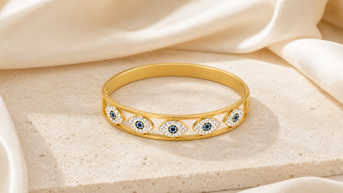 Gold evil eye protection bracelet The Aureveil Ward styled on warm ivory silk