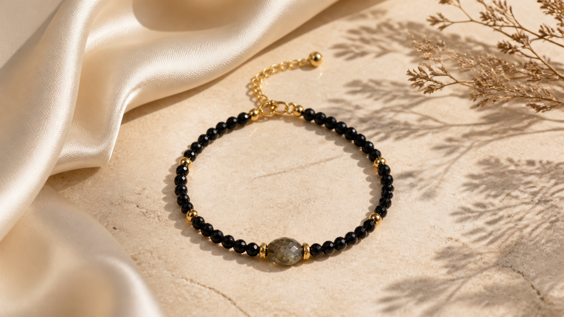 The Shadow Anchor black natural stone bracelet with smoky center bead and gold-tone accents