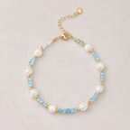 The Aqua Serenity Natural Aquamarine and Freshwater Pearl bracelet for calm and clarity, shown worn on wrist