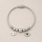 The Argent Veil silver evil eye bangle for protection energy and grounded boundaries, gift-ready styling image