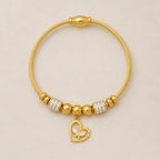 The Amorette Glow gold heart charm bangle for self-love and tender connection, main product image