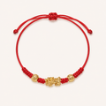 Red string Pixiu bracelet with a gold-tone charm and two engraved beads